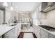 Spacious kitchen featuring white cabinets and quartz countertops, leading into an elegant dining area at 612 Concord Lake Se Cir, Smyrna, GA 30082