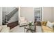Comfortable seating area with hardwood floors, staircase, and open view to the dining area at 612 Concord Lake Se Cir, Smyrna, GA 30082