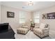 Comfortable living room with two armchairs, ottoman, and warm inviting decor at 612 Concord Lake Se Cir, Smyrna, GA 30082