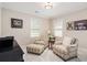 Cozy sitting room with two plaid chairs, ottoman, and natural light; perfect for relaxing and entertaining at 612 Concord Lake Se Cir, Smyrna, GA 30082