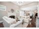 Bright living room with fireplace and white sofas opening to a modern kitchen with stainless appliances at 612 Concord Lake Se Cir, Smyrna, GA 30082