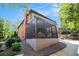 Screened-in porch connected to brick house, with outdoor seating and lovely backyard views at 612 Concord Lake Se Cir, Smyrna, GA 30082