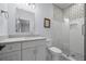 Modern bathroom featuring a white vanity with marble countertop and a frameless glass shower with white subway tile at 115 Trinity Hollow Dr, Canton, GA 30115