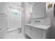 Neat bathroom with white cabinets, marble countertop, and walk-in tiled shower at 115 Trinity Hollow Dr, Canton, GA 30115