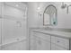 Well-lit bathroom with a marble countertop vanity and walk-in shower featuring decorative tiling at 115 Trinity Hollow Dr, Canton, GA 30115