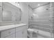 Modern bathroom featuring a gray vanity with marble countertop and frameless glass shower with white subway tile at 115 Trinity Hollow Dr, Canton, GA 30115