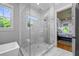 Contemporary shower with subway tile and a glass enclosure, adjoined to the primary bedroom at 115 Trinity Hollow Dr, Canton, GA 30115