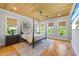 Charming bedroom featuring a wooden ceiling, four-poster bed, and plenty of natural light at 115 Trinity Hollow Dr, Canton, GA 30115