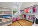 Well-organized walk-in closet with custom shelving and storage for clothing and accessories at 115 Trinity Hollow Dr, Canton, GA 30115