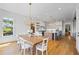 Open concept dining room with views of the kitchen features modern lighting and wood floors throughout at 115 Trinity Hollow Dr, Canton, GA 30115