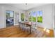 Bright dining room features hardwood floors, shiplap walls, and multiple windows with scenic outdoor views at 115 Trinity Hollow Dr, Canton, GA 30115
