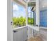 Inviting dutch door with a black handle opens to a beautiful brick floor and a wall with intricate blue and white wallpaper at 115 Trinity Hollow Dr, Canton, GA 30115