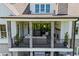 Rear elevation of the home featuring a covered outdoor patio, brick accents, and a well-maintained yard at 115 Trinity Hollow Dr, Canton, GA 30115