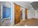 Hallway area with brick floors and sliding barn doors to the pantry, laundry room, and powder room at 115 Trinity Hollow Dr, Canton, GA 30115