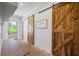 Hallway area features brick floors, a built-in bench, and sliding barn doors to the laundry and pantry at 115 Trinity Hollow Dr, Canton, GA 30115