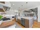 Bright eat-in kitchen features stainless steel appliances and a marble-topped island with a farmhouse sink at 115 Trinity Hollow Dr, Canton, GA 30115