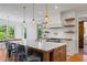Bright, spacious kitchen features a large island, marble countertop, pendant lights and modern appliances at 115 Trinity Hollow Dr, Canton, GA 30115