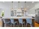Bright kitchen featuring a large island, bar stools, and modern stainless steel appliances at 115 Trinity Hollow Dr, Canton, GA 30115