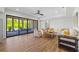 Open living room featuring wood flooring, a neutral sofa and large sliding glass doors at 115 Trinity Hollow Dr, Canton, GA 30115