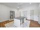 Well-lit home office with a large desk, modern lighting fixture, and hardwood floors at 115 Trinity Hollow Dr, Canton, GA 30115