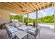Comfortable outdoor living space features seating, an outdoor kitchen, and views of the backyard at 115 Trinity Hollow Dr, Canton, GA 30115