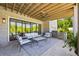 Inviting outdoor living area featuring a fireplace, outdoor kitchen, ample seating, and lush landscaping at 115 Trinity Hollow Dr, Canton, GA 30115