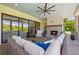 Covered outdoor patio featuring a fireplace, comfortable seating, and seamless connection to the indoor living space at 115 Trinity Hollow Dr, Canton, GA 30115