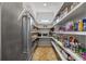 Pantry features a stainless steel fridge, open shelving, brick floors, and a small window for natural light at 115 Trinity Hollow Dr, Canton, GA 30115