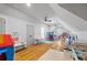 Spacious playroom with wood flooring, multiple play areas, and a vaulted ceiling with ceiling fans at 115 Trinity Hollow Dr, Canton, GA 30115