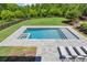 Stunning pool featuring a spa, lounge chairs and a lush green lawn surrounded by beautiful landscaping at 115 Trinity Hollow Dr, Canton, GA 30115