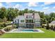 Stunning backyard with a modern pool, lounging area, and staircase leading to upper level porch at 115 Trinity Hollow Dr, Canton, GA 30115