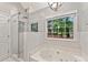 Bathroom featuring glass enclosed shower, soaking tub, and large windows at 4733 Julian Way, Acworth, GA 30101