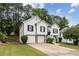 Charming two-story home with white siding, black shutters, two-car garage, arched front door, and well-maintained landscaping at 4733 Julian Way, Acworth, GA 30101