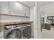 Laundry room features a Samsung washer and dryer, a wood countertop, and gray cabinets at 4733 Julian Way, Acworth, GA 30101