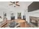 Bright open-plan living room with stone fireplace, hardwood floors, and seamless view into the dining area at 4733 Julian Way, Acworth, GA 30101