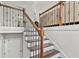 Staircase features wooden stairs, white risers, and iron railing, adding elegance to the home's interior at 4733 Julian Way, Acworth, GA 30101