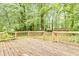Wooden backyard deck with lush greenery creating a serene outdoor space at 4808 Oak Ct, Ellenwood, GA 30294
