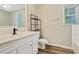 Updated bathroom with white vanity, modern fixtures, and wood-look flooring, blending style and functionality at 4808 Oak Ct, Ellenwood, GA 30294