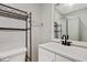 Bathroom with a white vanity, dark faucet and shower with glass doors at 4808 Oak Ct, Ellenwood, GA 30294