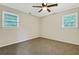 Clean and bright bedroom with neutral carpet, lots of natural light, and a ceiling fan at 4808 Oak Ct, Ellenwood, GA 30294