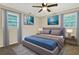 Comfortable bedroom featuring modern decor, soft carpeting, and ample natural light streaming through the windows at 4808 Oak Ct, Ellenwood, GA 30294