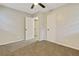 Neutral-toned bedroom featuring carpet, ceiling fan, and closet space at 4808 Oak Ct, Ellenwood, GA 30294