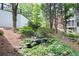Picturesque backyard with a small pond, a gentle waterfall, and lush greenery, creating a peaceful retreat at 5258 Tallgrass Nw Way, Kennesaw, GA 30152