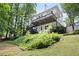 Expansive backyard view featuring a multi-level deck, lush greenery, and mature trees at 5258 Tallgrass Nw Way, Kennesaw, GA 30152