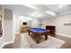 Finished basement featuring a pool table, foosball, and cozy seating area on a patterned rug over dark wood floors at 5258 Tallgrass Nw Way, Kennesaw, GA 30152