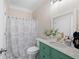Charming bathroom with green vanity, decorative fixtures, and patterned shower curtain at 5258 Tallgrass Nw Way, Kennesaw, GA 30152