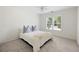 Bright bedroom with a large window, plush carpet, and a comfortable bed with pillows at 5258 Tallgrass Nw Way, Kennesaw, GA 30152
