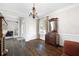 Formal dining room with hardwood floors, a vintage chandelier, and classic wainscoting at 5258 Tallgrass Nw Way, Kennesaw, GA 30152