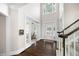 Elegant foyer with hardwood floors, soaring ceilings, and staircase leading to the upper level at 5258 Tallgrass Nw Way, Kennesaw, GA 30152