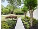 Pathway leading to a home, enhanced by artfully arranged shrubbery and flowerbeds with decorative mulch at 5258 Tallgrass Nw Way, Kennesaw, GA 30152
